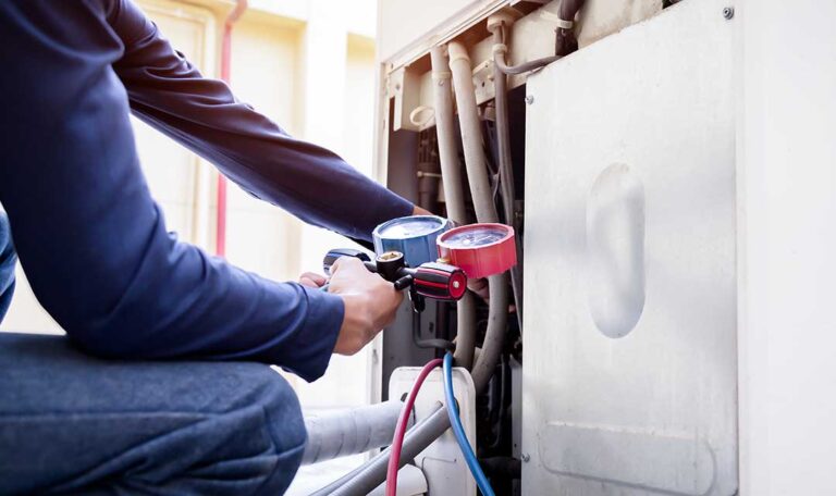 A homeowner adjusts a wall-mounted smart thermostat while a furnace and air-conditioning system operate in the background.